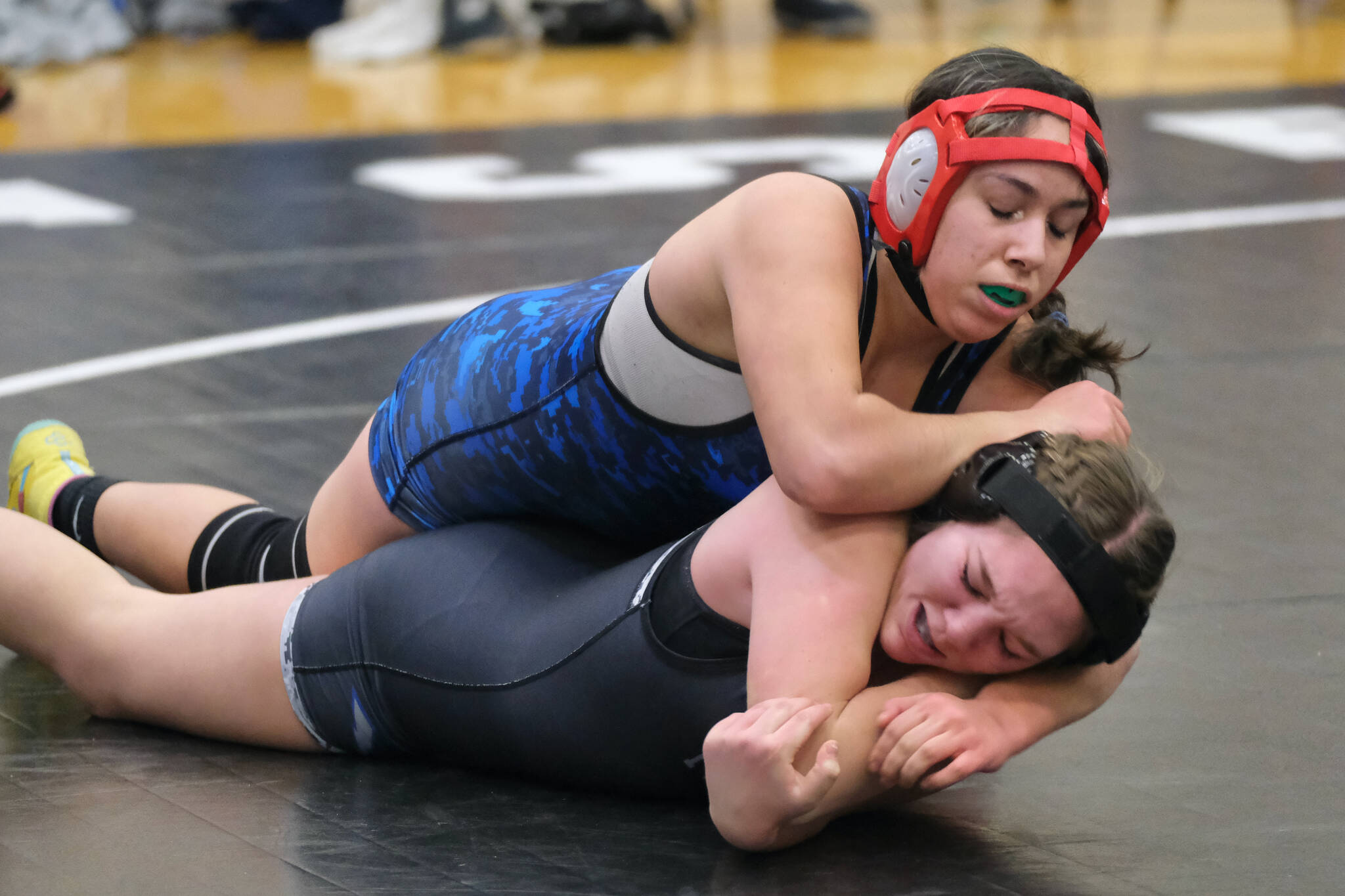 Thunder Mountain Middle School seventh grader Haylee Ondrejka team Blue Barracuda Bombers tries to get arm position against eighth grader Aurora Lee of War Hawks White during the inaugural Thunder Mountain Mayhem Team Duels wrestling tournament Saturday at TMMS. (Klas Stolpe / Juneau Empire)