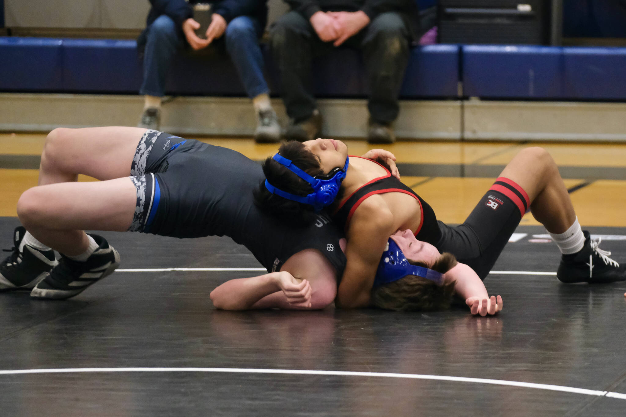 Orange Crush eighth grader Byron Jack attempts to pin Black Bear Legion classmate Camden Huff during the inaugural Thunder Mountain Mayhem wrestling tournament Saturday at Thunder Mountain Middle School. (Klas Stolpe / Juneau Empire)