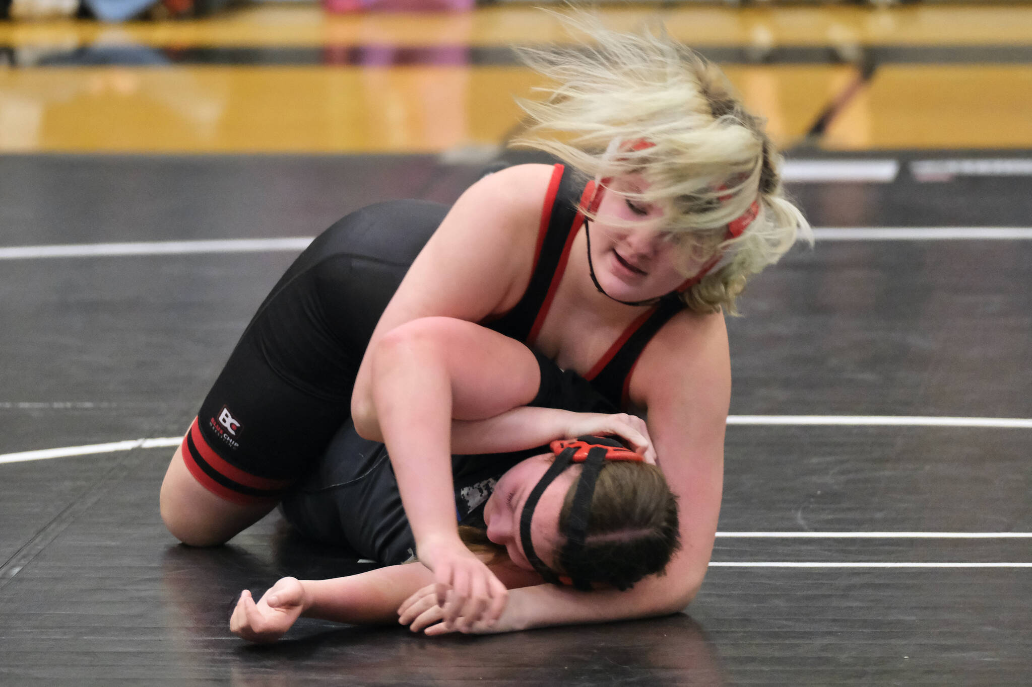 War Hawks White eighth grader Phoebe Martin works against Orange Crush classmate Kendall Mulkey during the inaugural Thunder Mountain Mayhem wrestling tournament Saturday at Thunder Mountain Middle School. (Klas Stolpe / Juneau Empire)