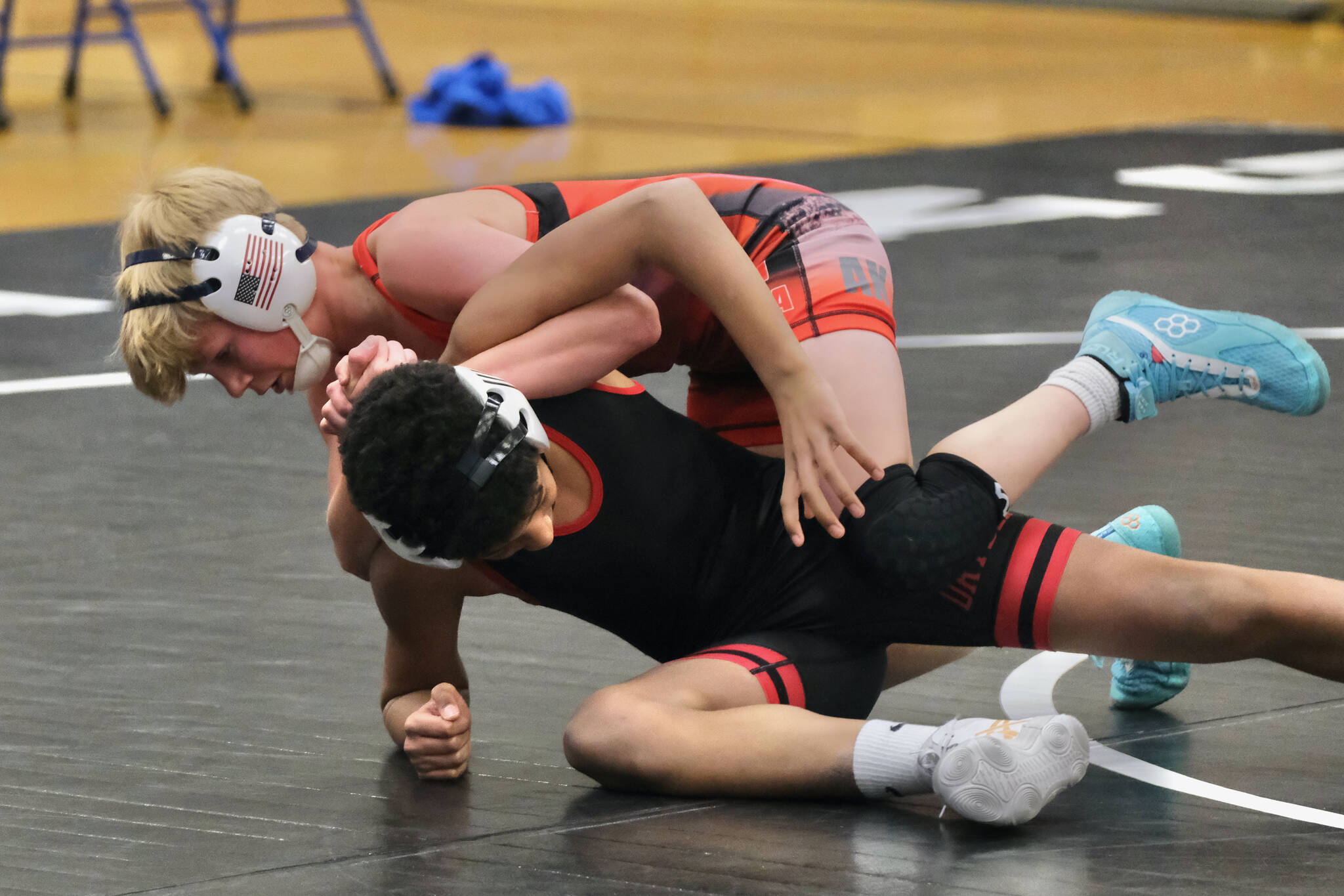 Black Bear Legion’s Rawley Cox tries a move on Orange Crush’s Momar Diouf during the inaugural Thunder Mountain Mayhem Team Duels wrestling tournament Saturday at Thunder Mountain Middle School. (Klas Stolpe / Juneau Empire)