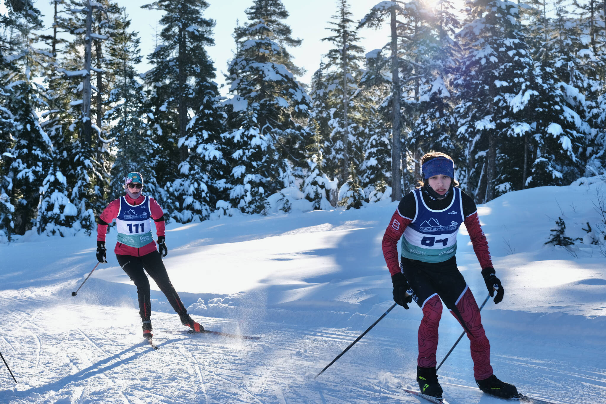 Community skier Aldyn Brudie (111) and JDHS Nordic Ski senior Finley Hightower (64) race during the Shaky Shakeout Invitational six-kilometer freestyle mass start Saturday at Eaglecrest Ski Area. (Klas Stolpe / Juneau Empire)