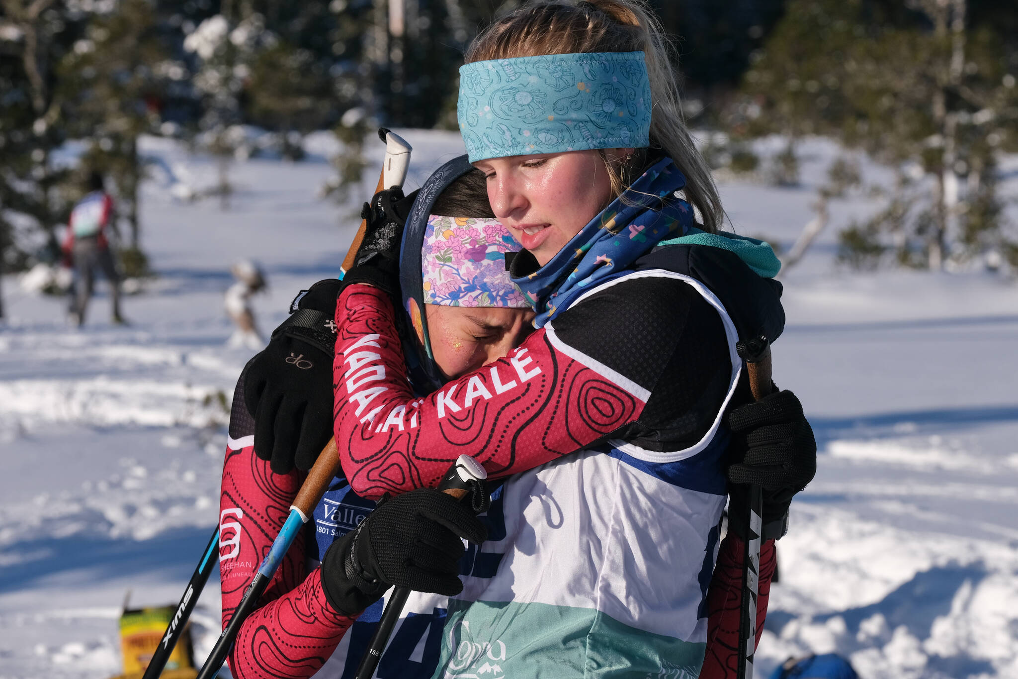 Juneau-Douglas High School: Yadaa.at Kalé Nordic Ski Team sophomore Kaia Mangaccat and senior Ida Meyer embrace at the finish of the Shaky Shakeout Invitational six-kilometer freestyle mass start race Saturday at Eaglecrest Ski Area. (Klas Stolpe / Juneau Empire)