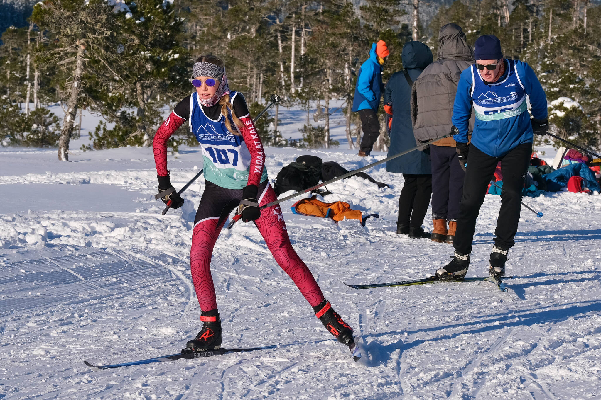 Juneau-Douglas High School: Yadaa.at Kalé Nordic Ski Team freshman Sigrid Eller (107) leads community skier Tim Blust (96) during the Shaky Shakeout Invitational six-kilometer freestyle mass start Saturday at Eaglecrest Ski Area. (Klas Stolpe / Juneau Empire)