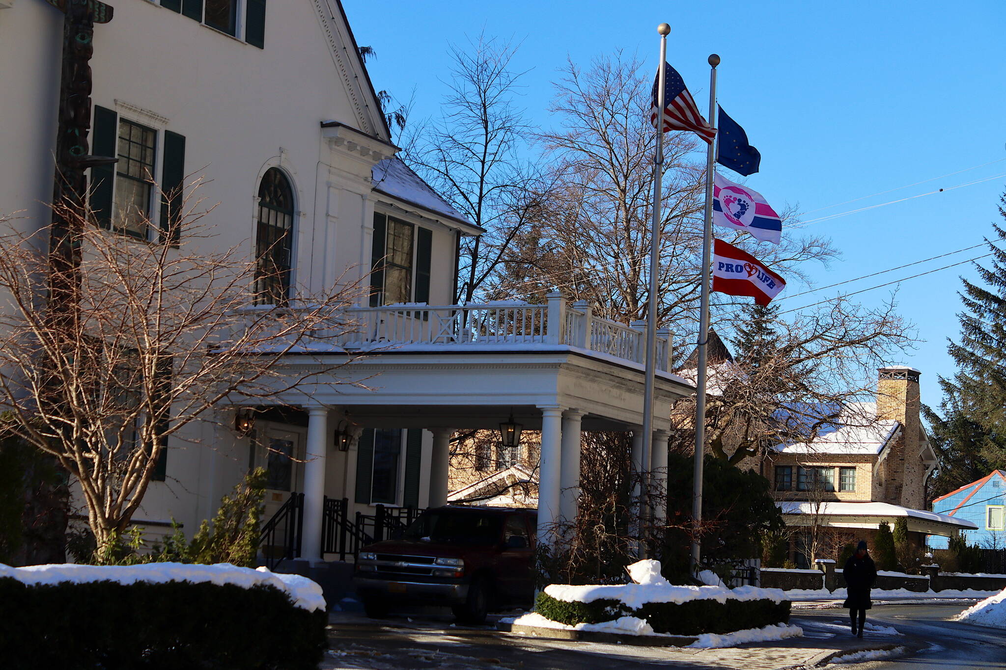 Two flags with pro-life themes, including the lower one added this week to one that’s been up for more than a year, fly along with the U.S. and Alaska state flags at the Governor’s House on Tuesday. (Mark Sabbatini / Juneau Empire)