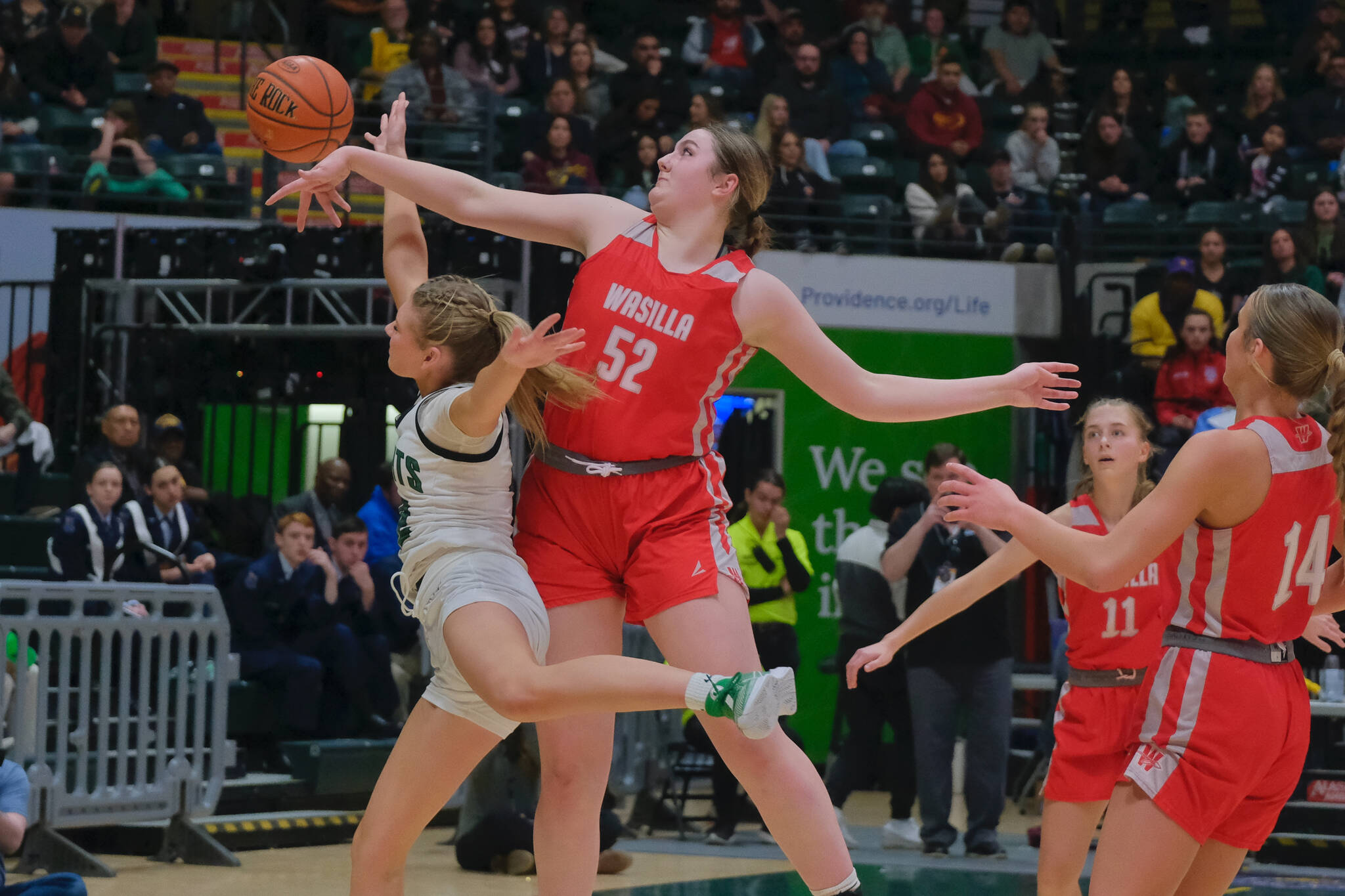 Wasilla’s Layla Hays blocks a Colony shot in the Warriors win over the Knights in last season’s state title game. Hays, a senior, and her number-one ranked Warriors play JDHS inside the George Houston Gymnasium on Friday and Saturday. (Klas Stolpe / Juneau Empire file photo)