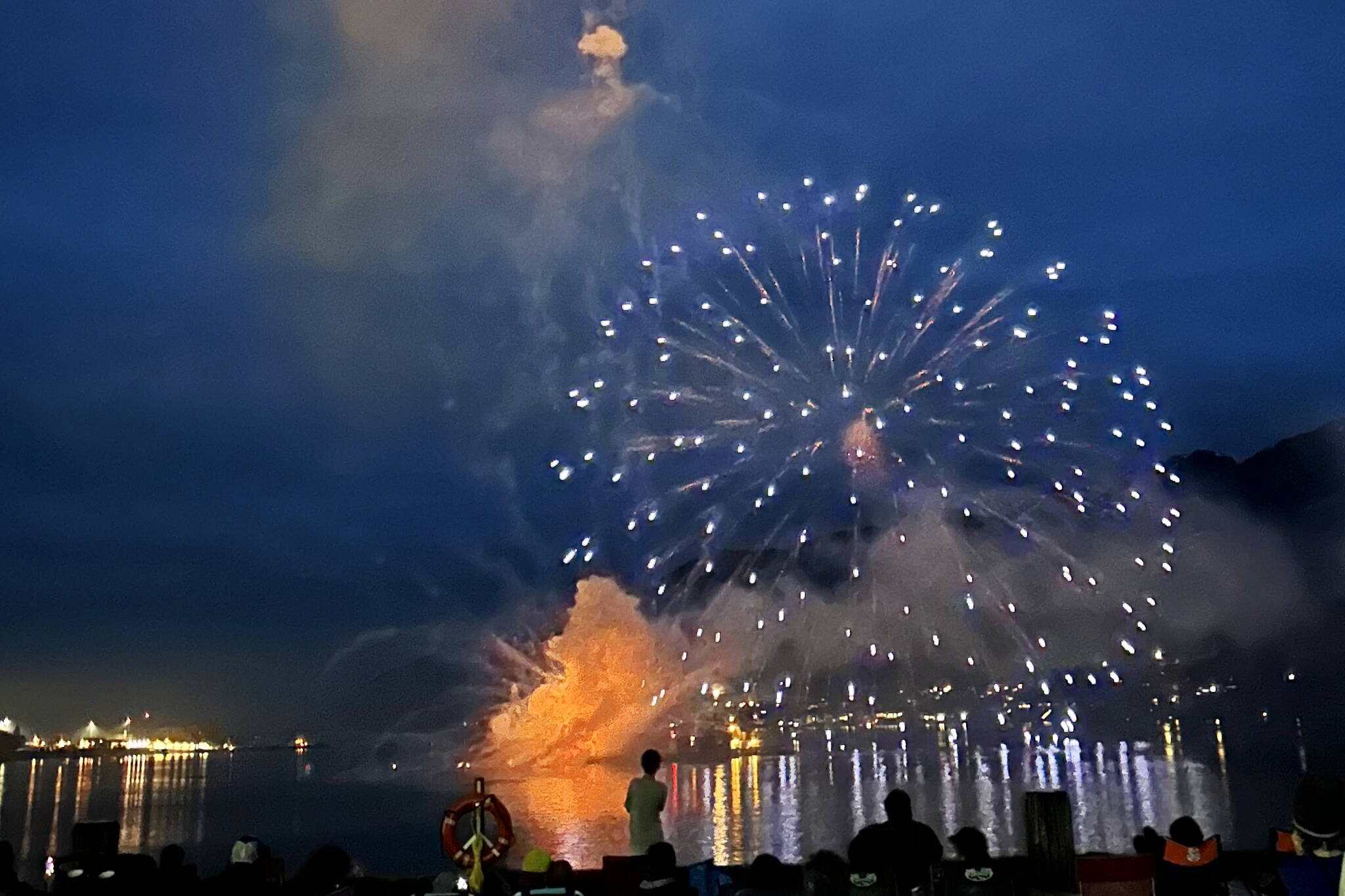 Fireworks detonate just above a barge in Gastineau Channel due to a mishap during the show that began just after midnight on July 4, 2023. (Photo by Bob Gross)