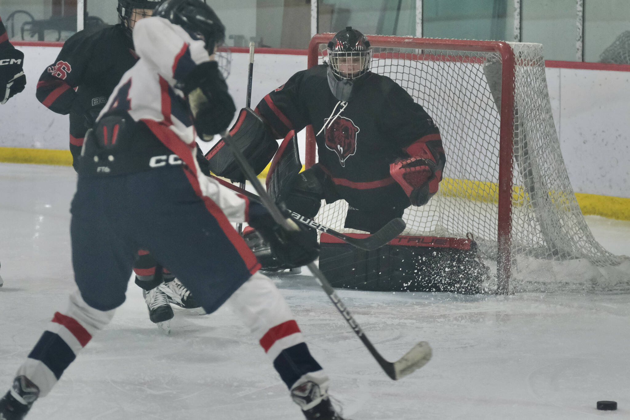 Juneau-Douglas High School: Yadaa.at Kalé senior goalie Caleb Friend protects the net against North Pole earlier this season. Friend had 33 saves in Thursday’s 5-4 extra-time win over the Houston Hawks to open the 2025 ASAA Division II Hockey State Tournament at Soldotna. (Klas Stolpe / Juneau Empire file photo)