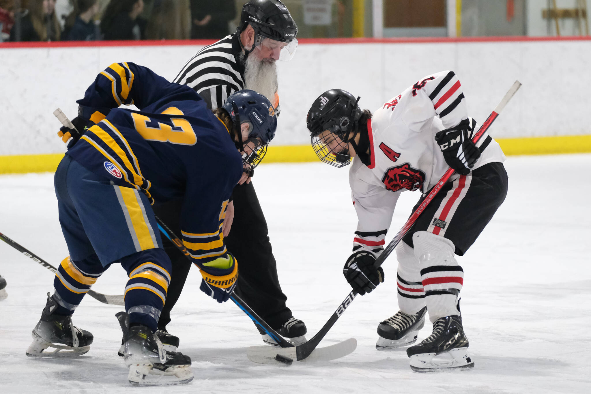 Juneau-Douglas High School: Yadaa.at Kalé senior Dylan Sowa (35) beats Bartlett senior Wyatt Rust (13) in a faceoff earlier this season. Sowa scored four goals in Thursday’s 5-4 extra-time win over the Houston Hawks to open the 2025 ASAA Division II Hockey State Tournament at Soldotna. (Klas Stolpe / Juneau Empire file photo)