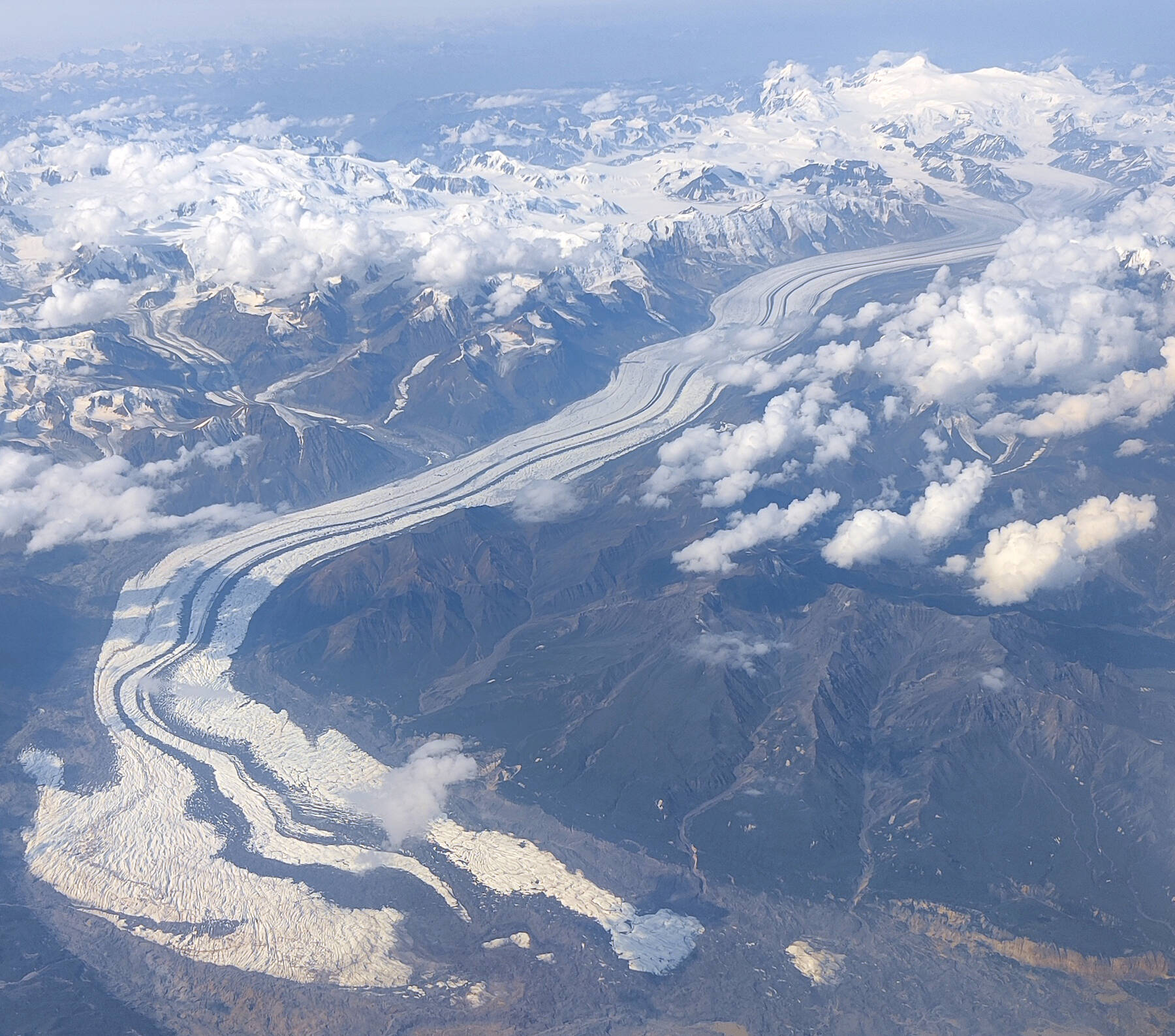 The Klutlan Glacier flows into the Yukon from Alaska’s Mount Bona, the highest peak in the photo, and Mount Churchill, the high ridge to the right of Bona. (Image courtesy the Alaska Volcano Observatory/Alaska Division of Geological and Geophysical Surveys)