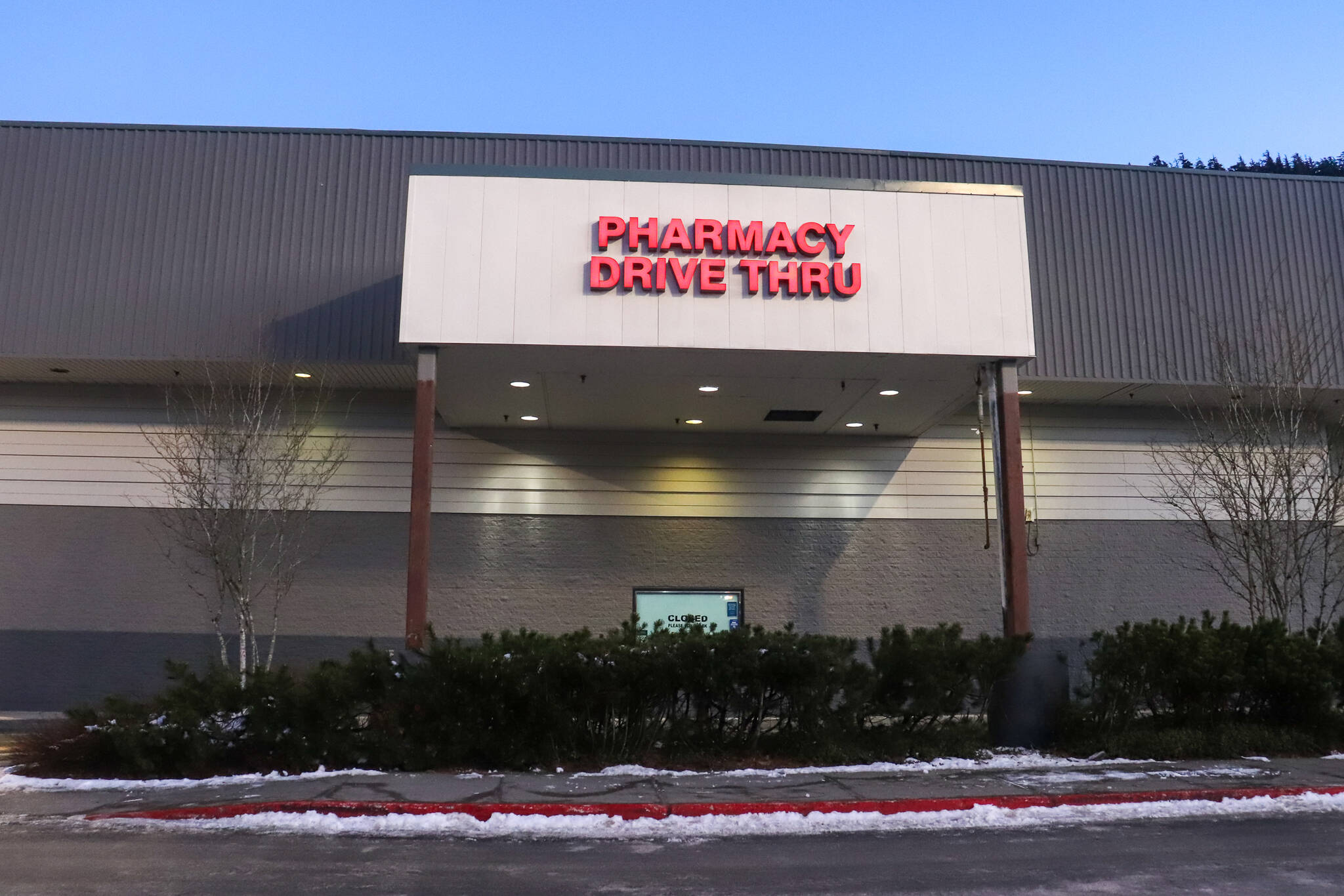 Blank posts are seen where the two totem poles once stood at the Fred Meyer main entrance on Feb. 7, 2025. (Jasz Garrett / Juneau Empire)