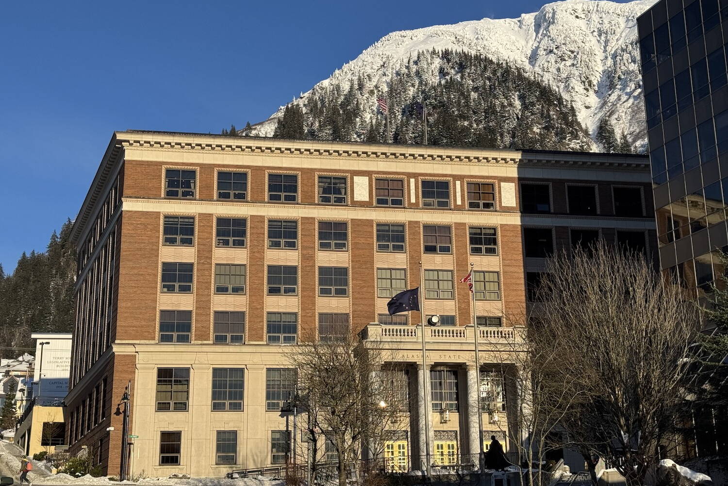 The Alaska State Capitol is seen on Monday, Feb. 3, 2025, in front of snow-covered Mount Juneau. (James Brooks/Alaska Beacon)