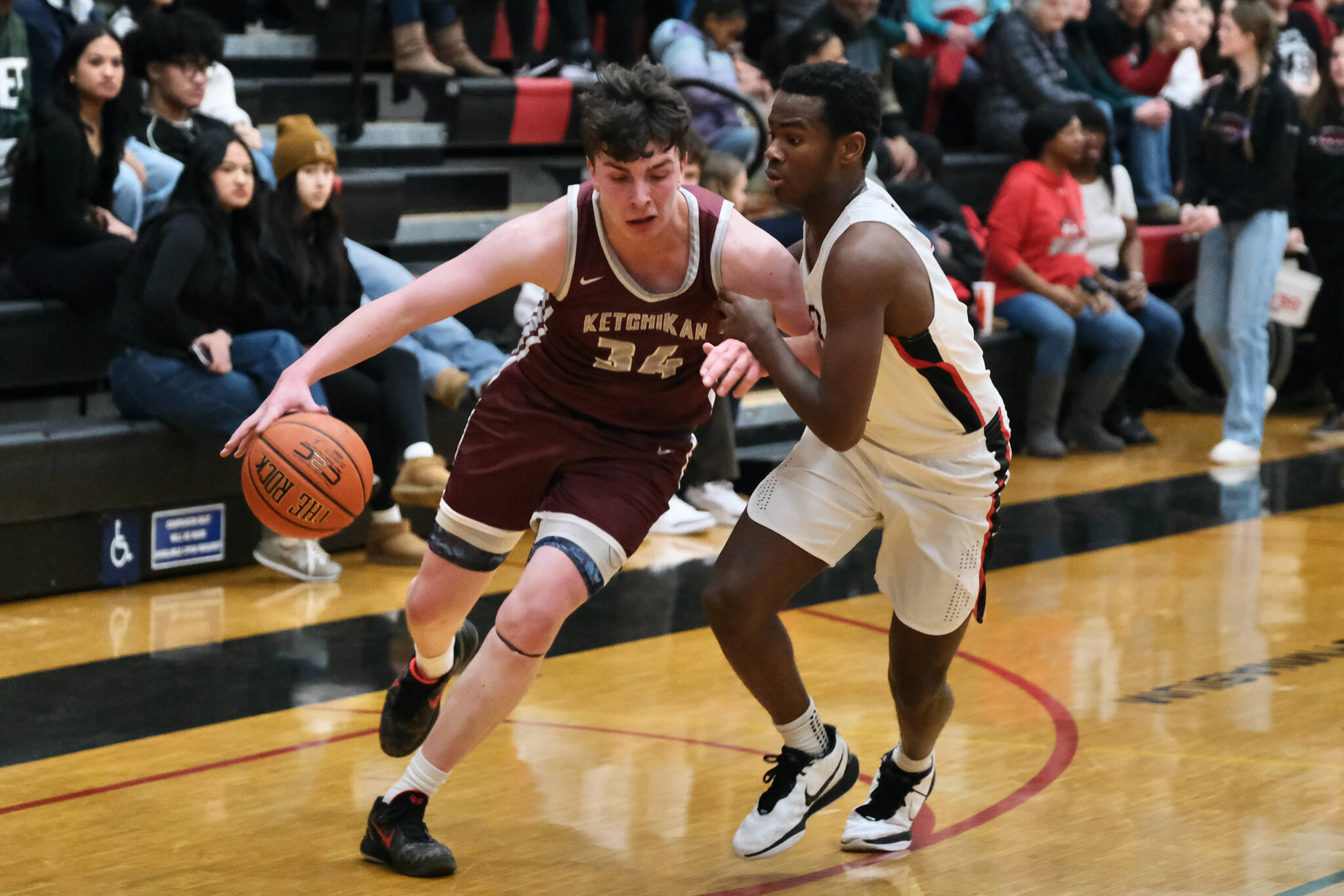 Juneau-Douglas High School: Yadaa.at Kalé senior Ahmir Parker (2) guards Ketchikan senior Marcus Stockhausen (34) during their series early in the season at JDHS. Parker has been a "jack-of-all-trades" for the Crimson Bears this season. (Klas Stolpe / Juneau Empire)