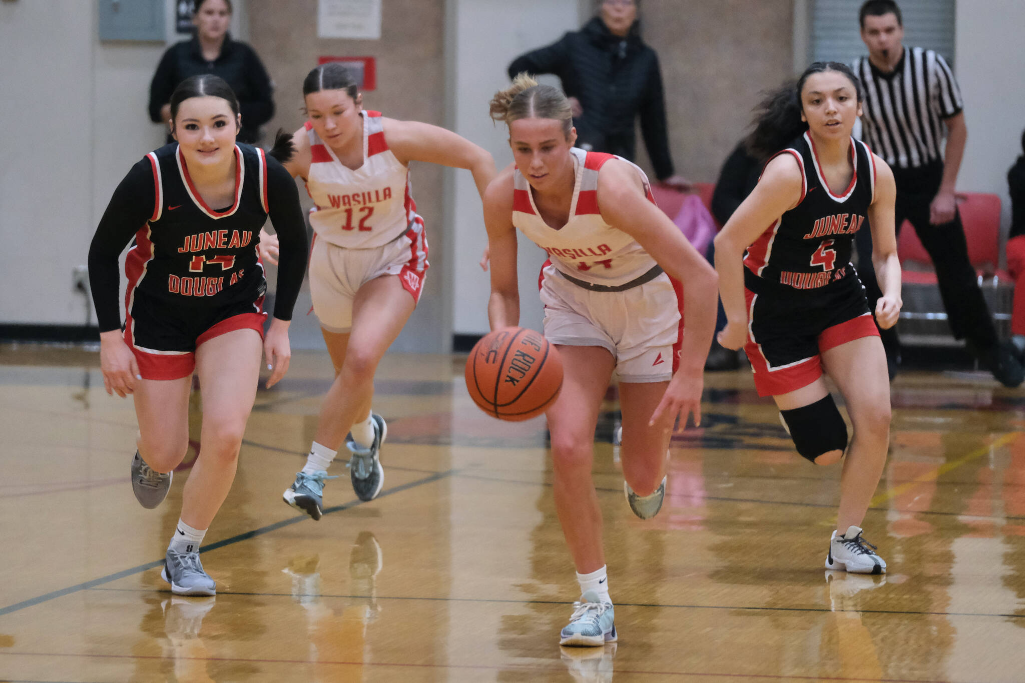 Juneau-Douglas High School: Yadaa.at Kalé sophomore Layla Tokuoka (14), Wasilla junior Kinley Lynch (12), Wasilla senior Mylee Anderson (14) and JDHS senior Mary Johnson (4) race for a ball during a Crimson Bears loss to the Warriors last weekend in the George Houston Gymnasium. JDHS will host Ketchikan at 7 p.m. Thursday and Friday. (Klas Stolpe / Juneau Empire)