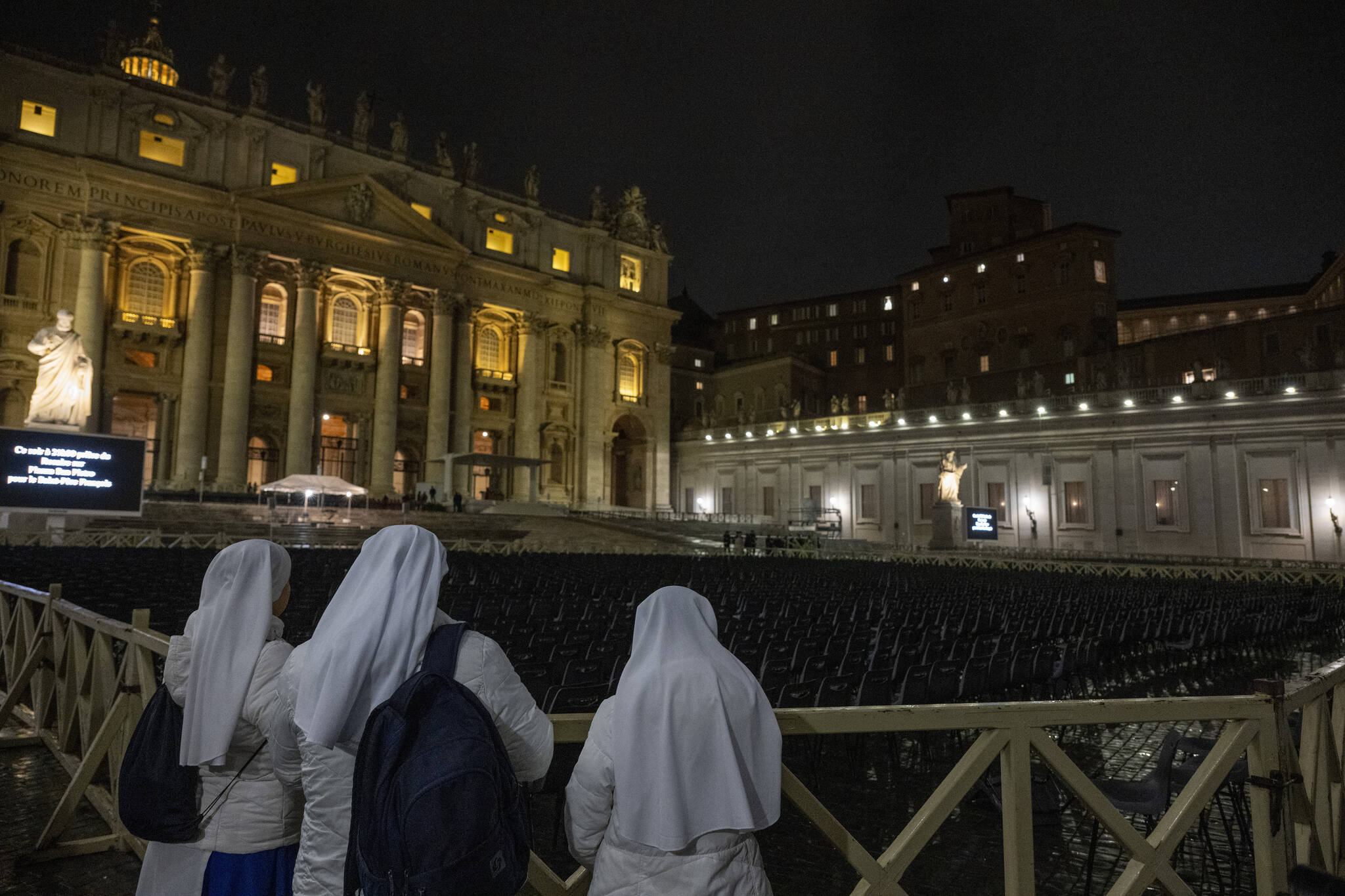 Nuns wait for a seating area to be opened before a recitation of the rosary for Pope Francis’ health at St. Peter’s Square in Vatican City, on Monday night, Feb. 24, 2025. (James Hill/The New York Times)