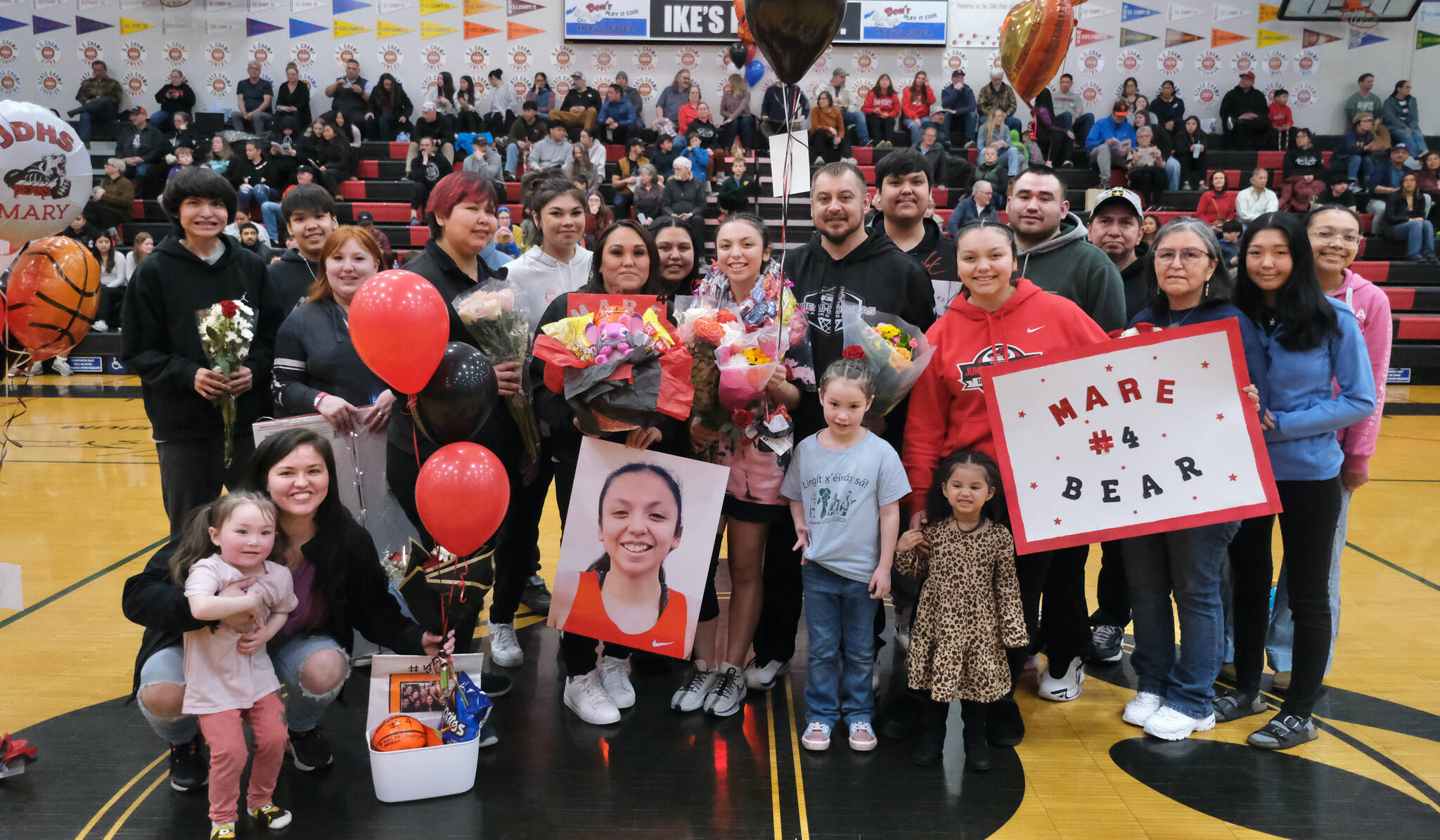 Friends and family of Juneau-Douglas High School: Yadaa.at Kalé Crimson Bears senior Mary Johnson during Senior Night honors Saturday at the George Houston Gymnasium. (Klas Stolpe / Juneau Empire)