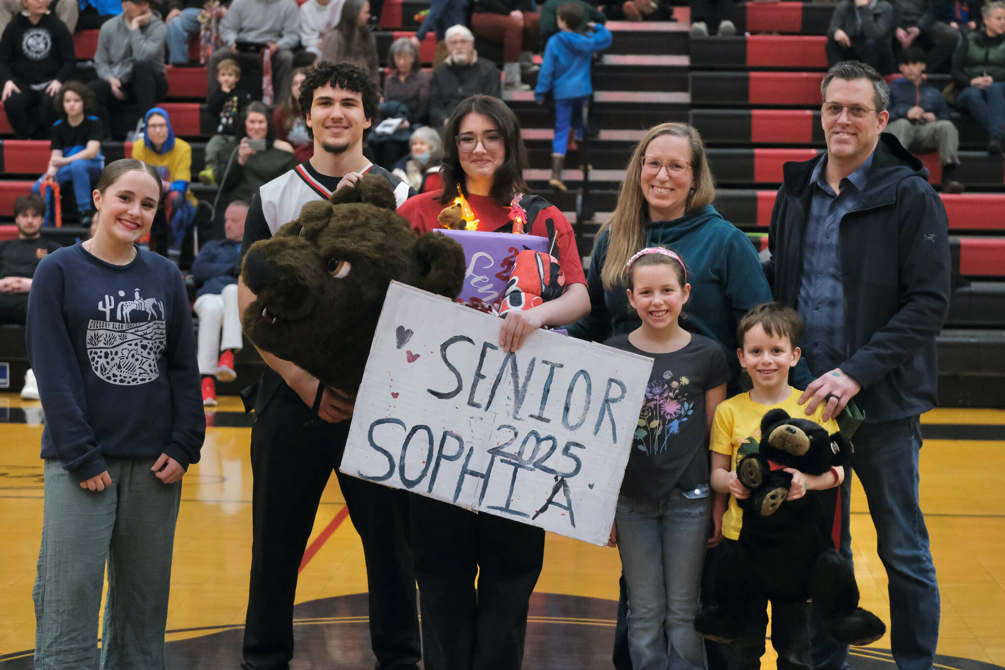 Friends and family of Juneau-Douglas High School: Yadaa.at Kalé Crimson Bears senior Sophia Percy during Senior Night honors Saturday at the George Houston Gymnasium. (Klas Stolpe / Juneau Empire)