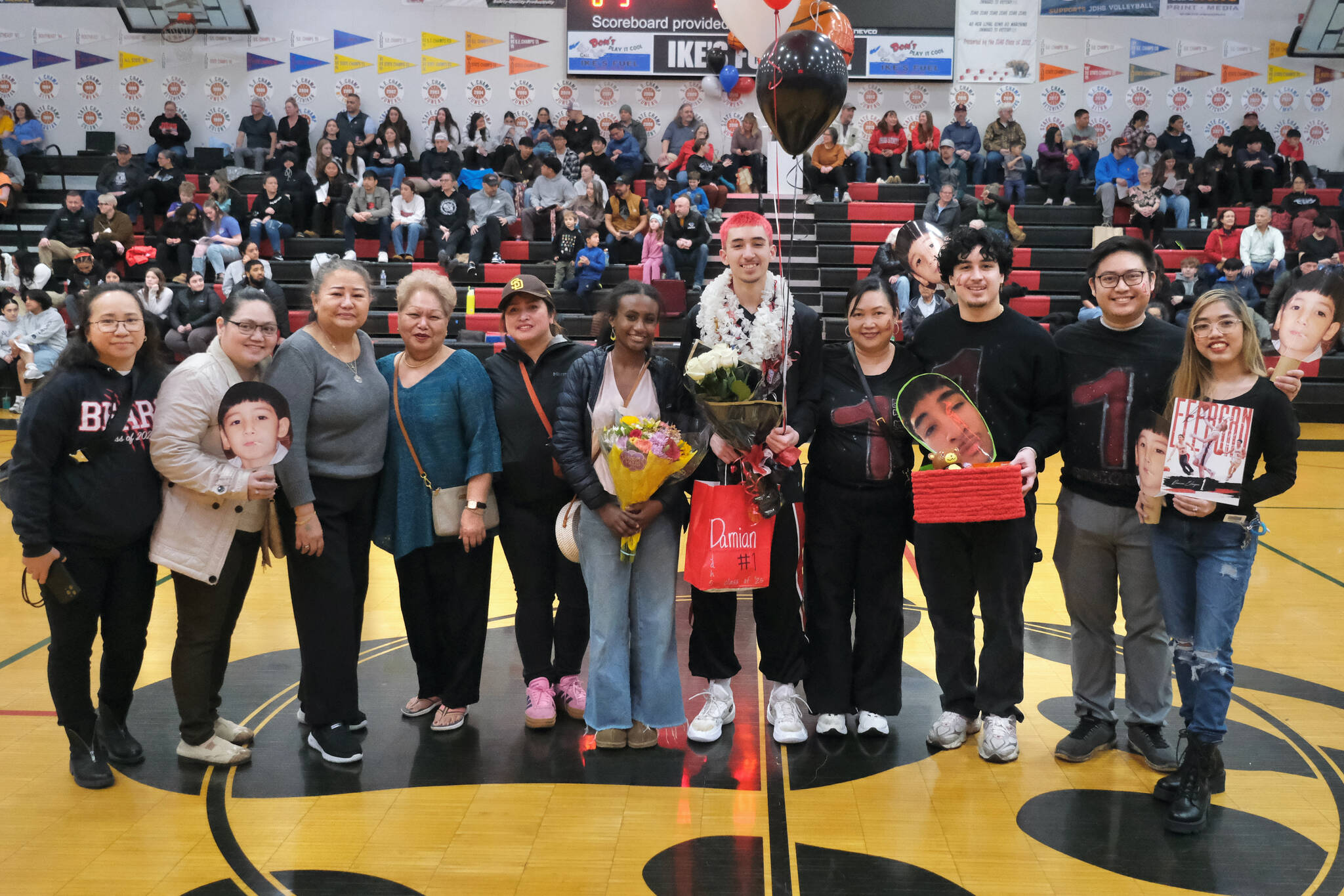 Friends and family of Juneau-Douglas High School: Yadaa.at Kalé Crimson Bears senior Damian Efergan during Senior Night honors Saturday at the George Houston Gymnasium. (Klas Stolpe / Juneau Empire)