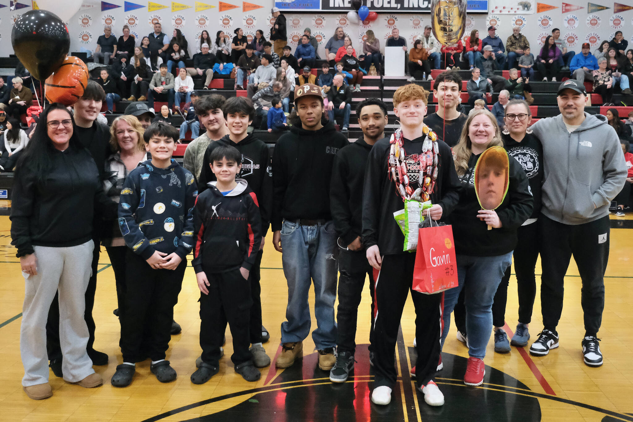 Friends and family of Juneau-Douglas High School: Yadaa.at Kalé Crimson Bears senior Gavin Gerrin during Senior Night honors Saturday at the George Houston Gymnasium. (Klas Stolpe / Juneau Empire)