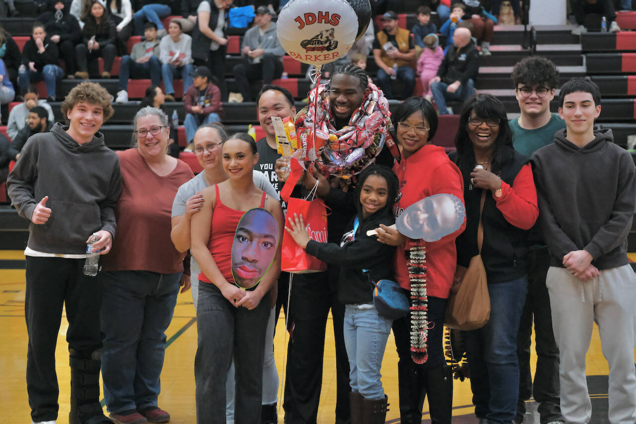 Friends and family of Juneau-Douglas High School: Yadaa.at Kalé Crimson Bears senior Ahmir Parker during Senior Night honors Saturday at the George Houston Gymnasium. (Klas Stolpe / Juneau Empire)