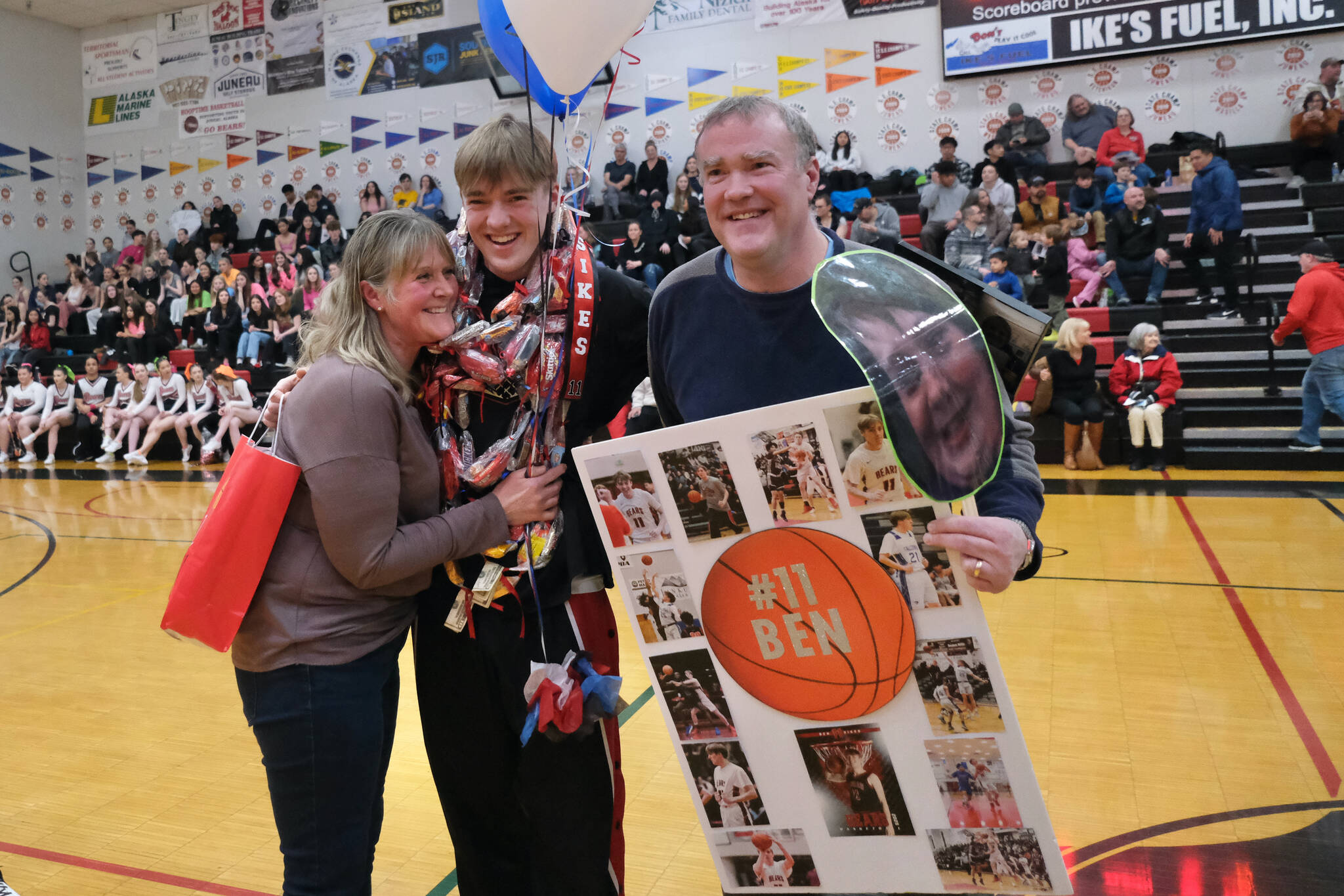 Juneau-Douglas High School: Yadaa.at Kalé Crimson Bears senior Ben Sikes with parents Heather and Steve during Senior Night honors Saturday at the George Houston Gymnasium. (Klas Stolpe / Juneau Empire)