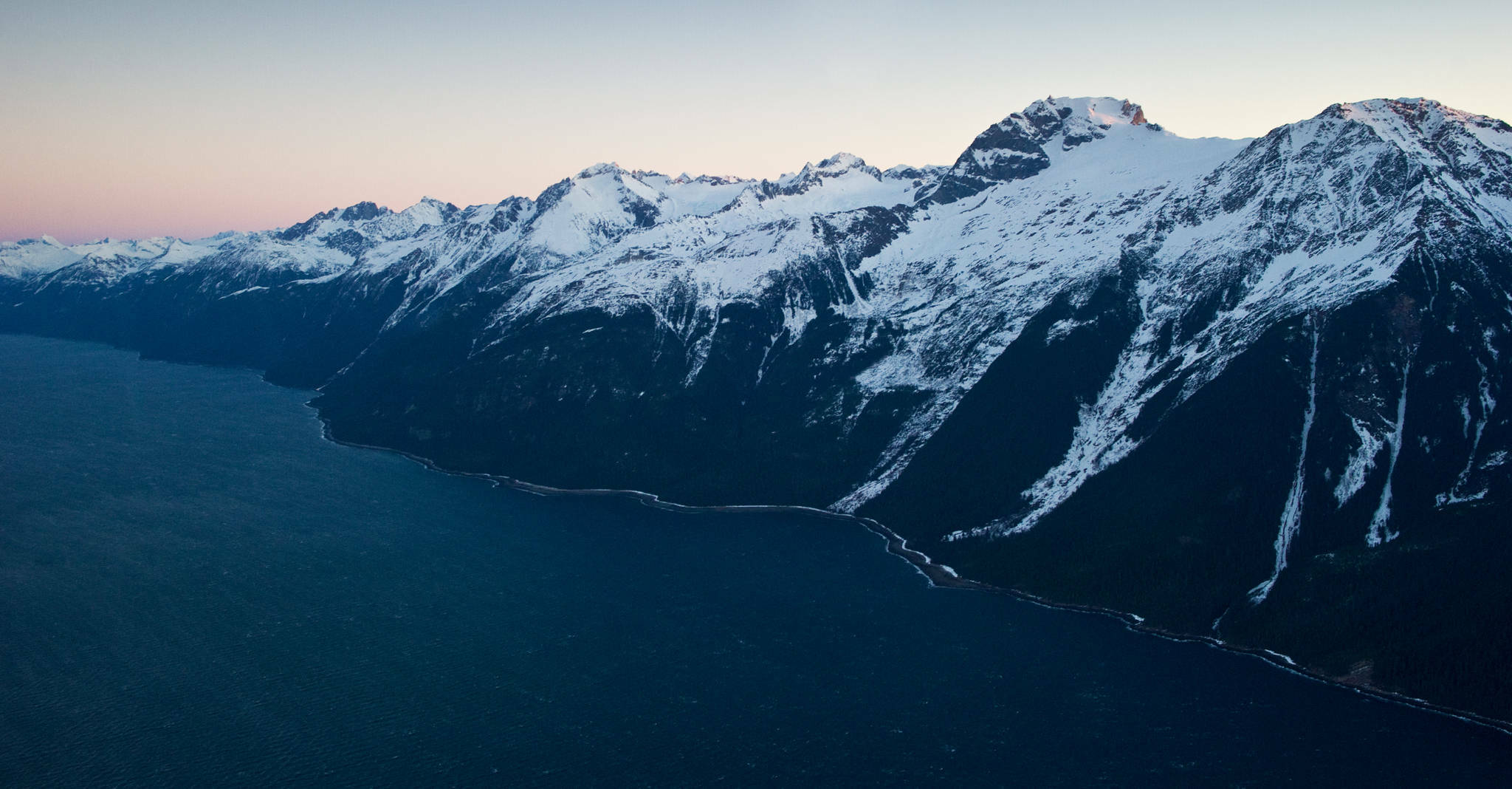 A road north of Juneau would have to negotiate the steep terrain of the east side of Lynn Canal, pictured here in February of 2014. (Michael Penn / Juneau Empire file pohoto)