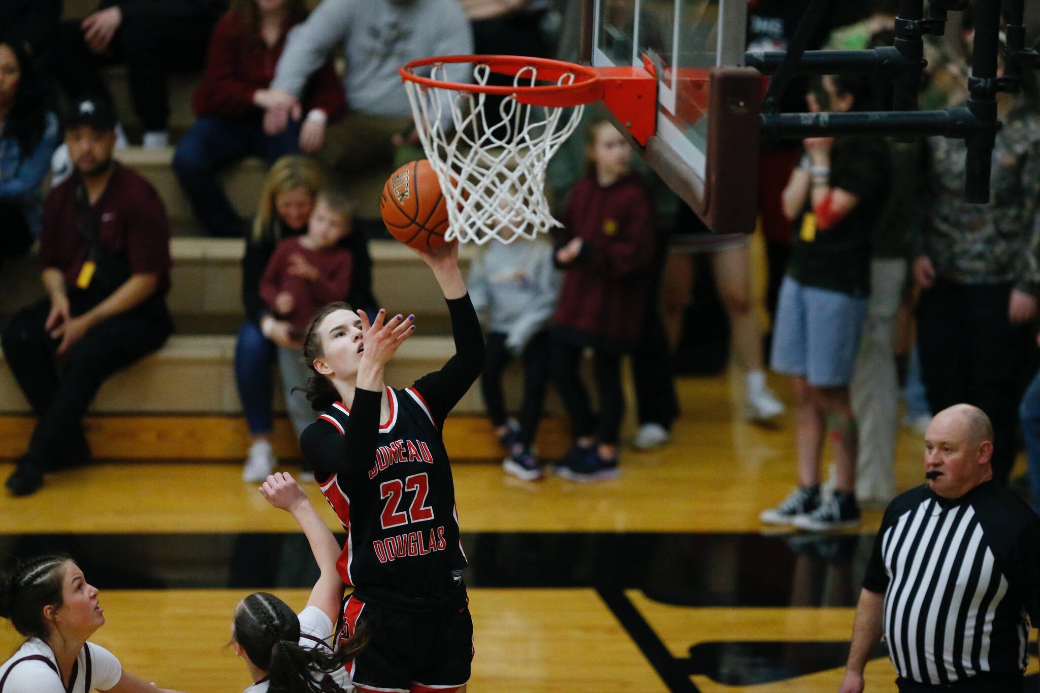 Juneau-Douglas High School: Yadaa.at Kalé’s Kerra Baxter makes a layup during Juneau-Douglas’s 65-43 victory over Ketchikan, winning the Region V 4A Basketball Tournament at the Clarke Cochrane Gymnasium on Friday. Juneau-Douglas eliminated Ketchikan and will advance to play at state. (Christopher Mullen / Ketchikan Daily News)