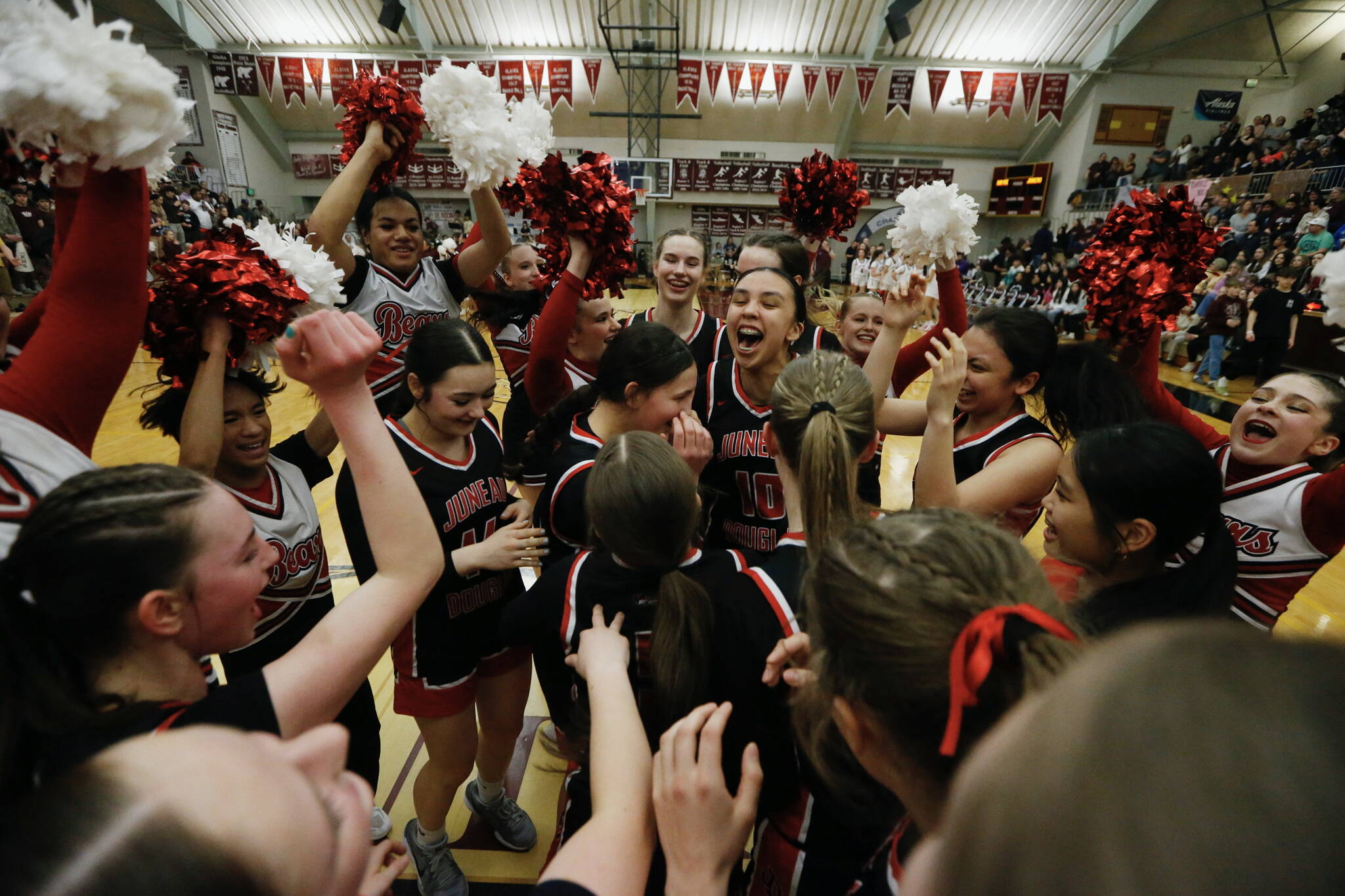 Juneau-Douglas High School: Yadaa.at Kalé players celebrate their 65-43 victory over Kayhi, winning the Region V 4A Basketball Tournament at the Clarke Cochrane Gymnasium on Friday. Juneau-Douglas eliminated Kayhi and will advance to play at state. (Christopher Mullen / Ketchikan Daily News)