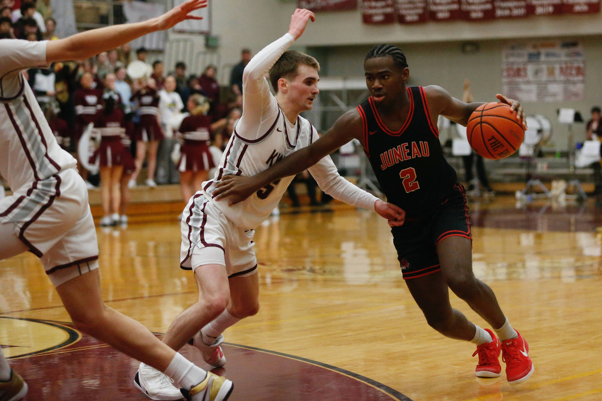 Juneau-Douglas High School: Yadaa.at Kalé’s Amir Parker runs around Ketchikan’s Gage Massin during Ketchikan’s 74-54 victory over Juneau-Douglas, winning the Region V 4A Basketball Tournament at the Clarke Cochrane Gymnasium on Friday. Ketchikan eliminated Juneau-Douglas and will advance to play at state. (Christopher Mullen / Ketchikan Daily News)