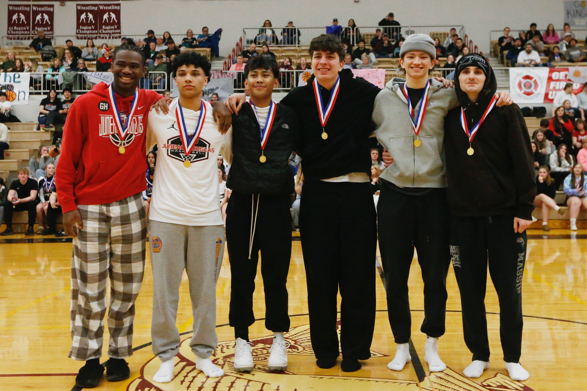 The 4A Boys All Conference players Juneau-Douglas’ Ahmir Parker, Pedrin Saceda Hurt, Joren Gasga, Kayhi’s Marcus Stockhausen, Jonathan Scoblic and Gage Massin stand for a photo at the Clarke Cochrane Gymnasium on Saturday. (Christopher Mullen / Ketchikan Daily News)