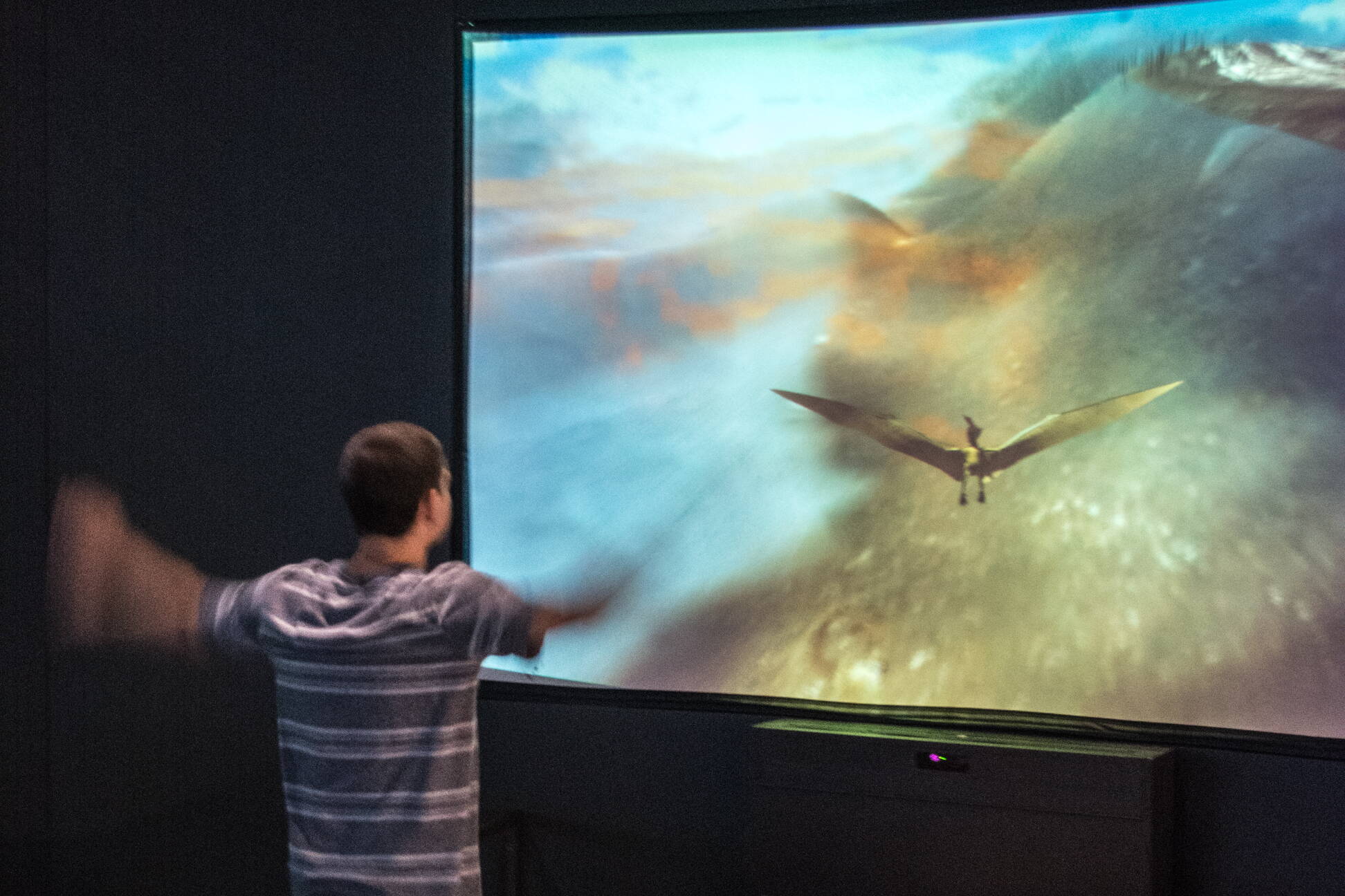 A museum visitor mimics pterosaurs flight in the age of the dinosaurs. (Tim Evanson / Creative Commons Attribution-Share Alike 2.0 Generic license)